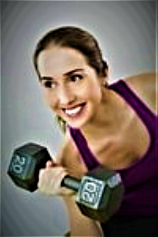 Success displayed with a lady holding one dumbbell in a smilimg pose