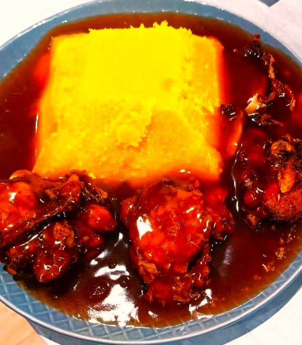 MiGold Yellow Gari Eba with chicken gravy stew on a plate