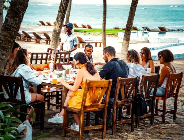 A group of friends having lunch at the Ningo Prampram beach