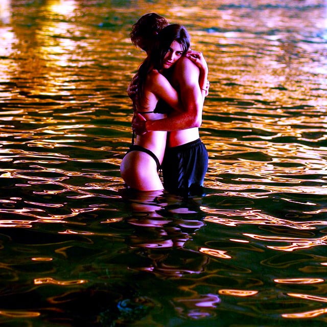 Couple embracing in water.